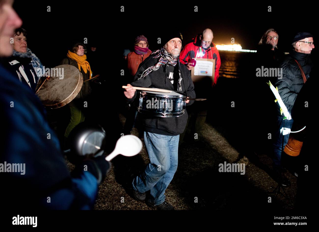 Hooksiel, Germania. 03rd Jan, 2023. Diversi ambientalisti cantano e si annodano nel porto esterno di Hooksiel, di fronte al terminal GNL nel Mare del Nord. Criticano lo scarico di cloro e bromo in mare e temono danni al mare di Wadden causati dalle operazioni terminali. Questa mattina, una petroliera con un carico completo di gas naturale liquefatto è arrivata al terminal GNL di Wilhelmshaven per la prima volta dalla sua apertura. Credit: Hauke-Christian Dittrich/dpa/Alamy Live News Foto Stock