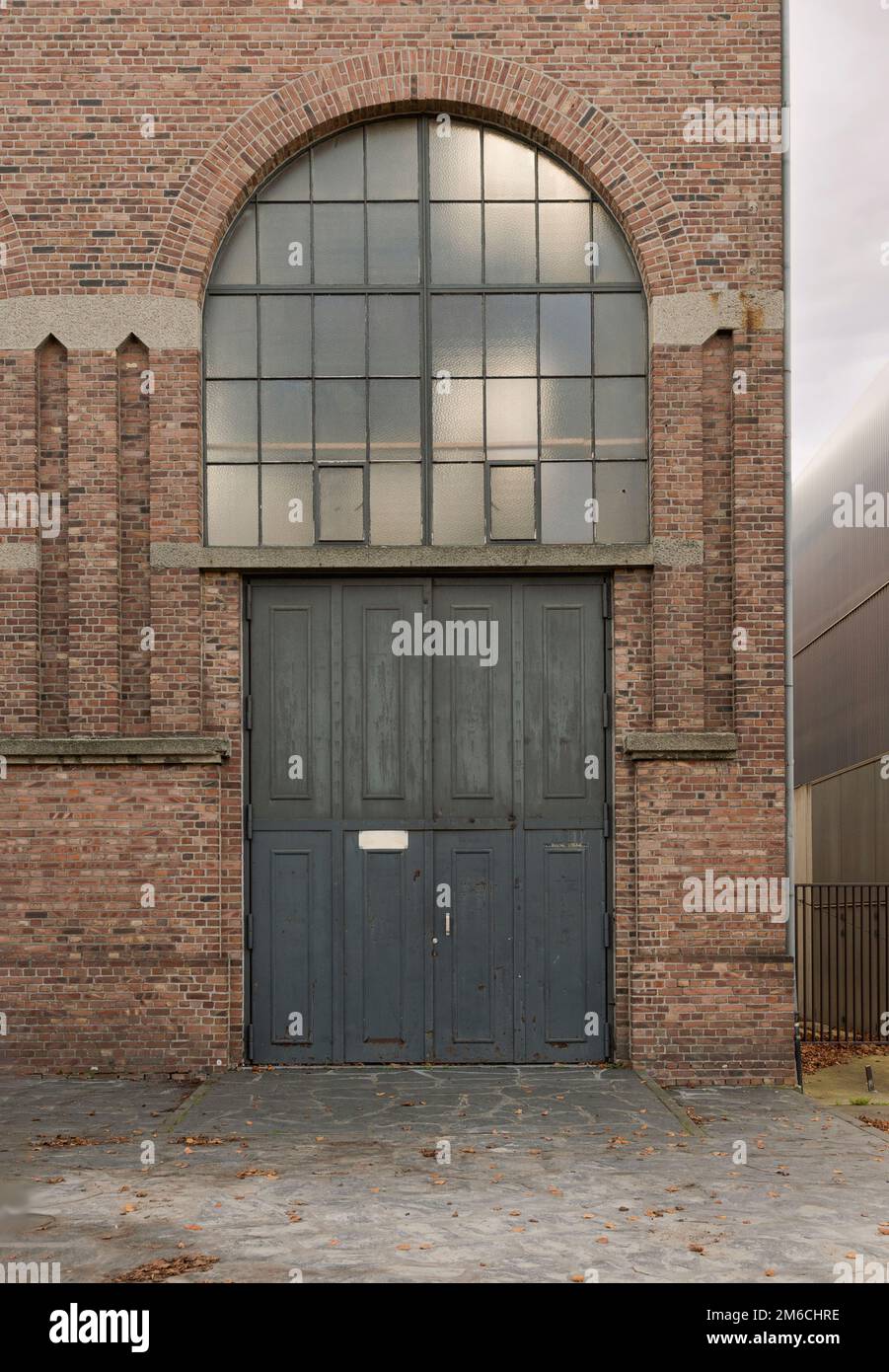 Genk. Limburgo - Belgio 10-11-2020. Frammento di un vecchio edificio con un cancello e una vetrata. Tardo 19th inizio 20th ° secolo stile Foto Stock