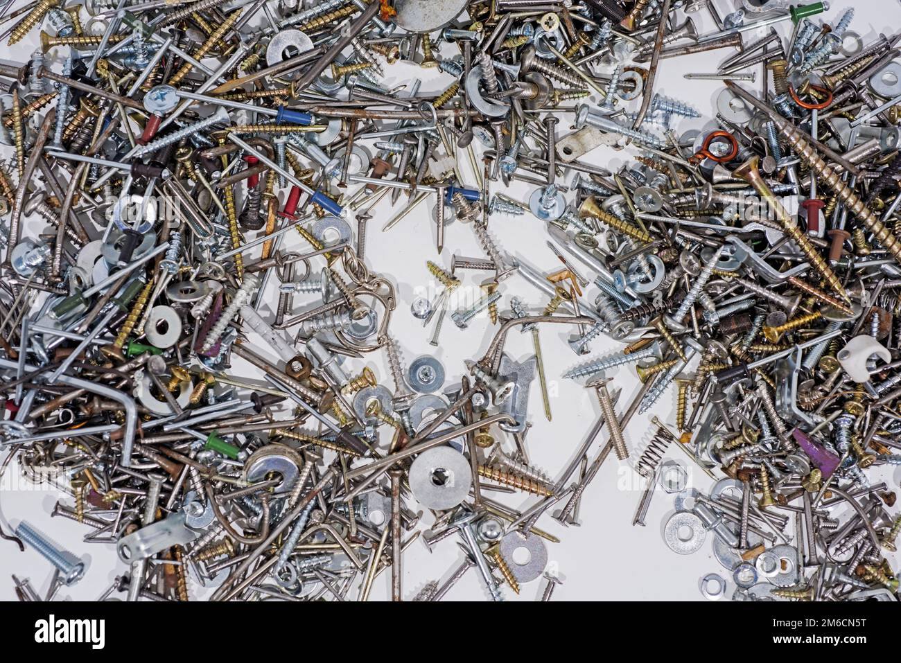 Molti denti, viti, bulloni e umori su sfondo bianco. Foto Stock