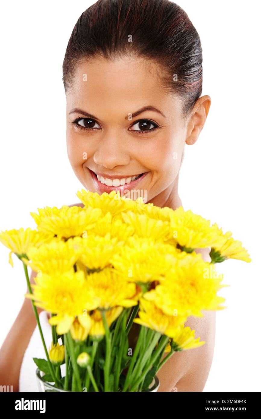 Il miglior regalo. Ritratto di una giovane donna attraente che tiene un mazzo di fiori gialli e sorridente. Foto Stock