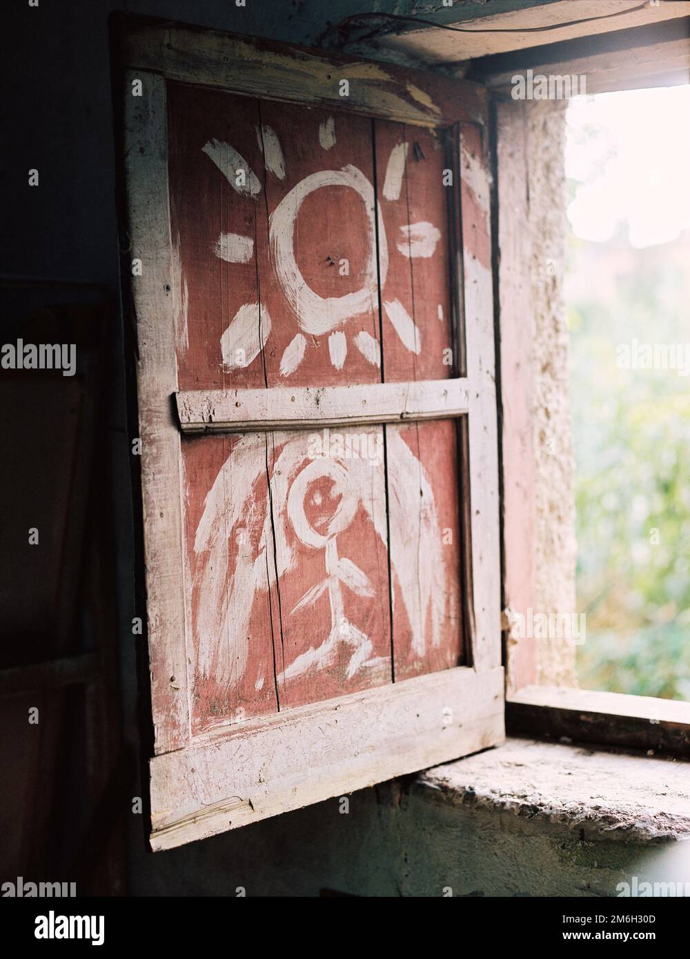 Uno scatto verticale di una porta rossa con bellissimi dipinti Foto Stock