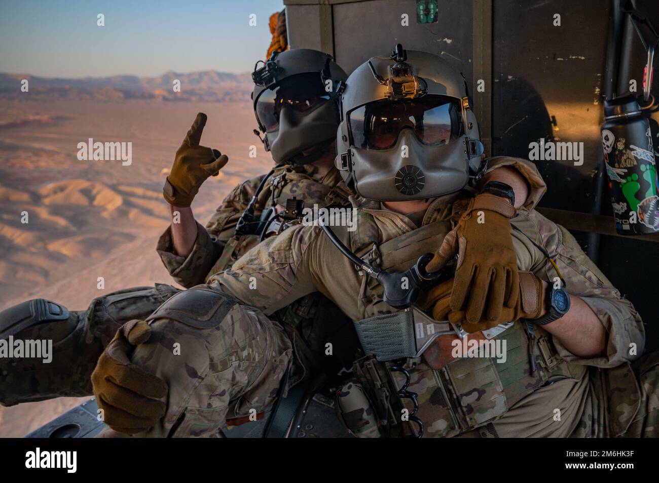 Tecnico. Jeffrey Hegstrom (a sinistra) e il personale Sgt. Dominic Brinker (a destra), 66th Rescue Squadron (RQS) missioni speciali aviatori istruttori, celebrano l'ultimo volo di Brinker con il 66 RQS il 28 aprile 2022 sul Nevada Test and Training Range. La missione del sistema RQS 66 è fornire forze di ricerca e salvataggio in combattimento agili, rapide e dispiegabili in risposta alle operazioni di emergenza in tutto il mondo. Foto Stock