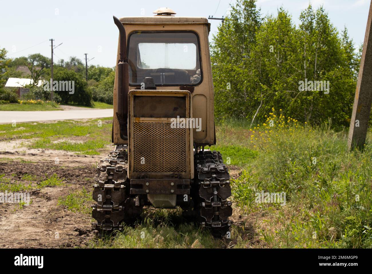 Il trattore in funzione si trova su un campo in Ucraina per scavare terreno Foto Stock