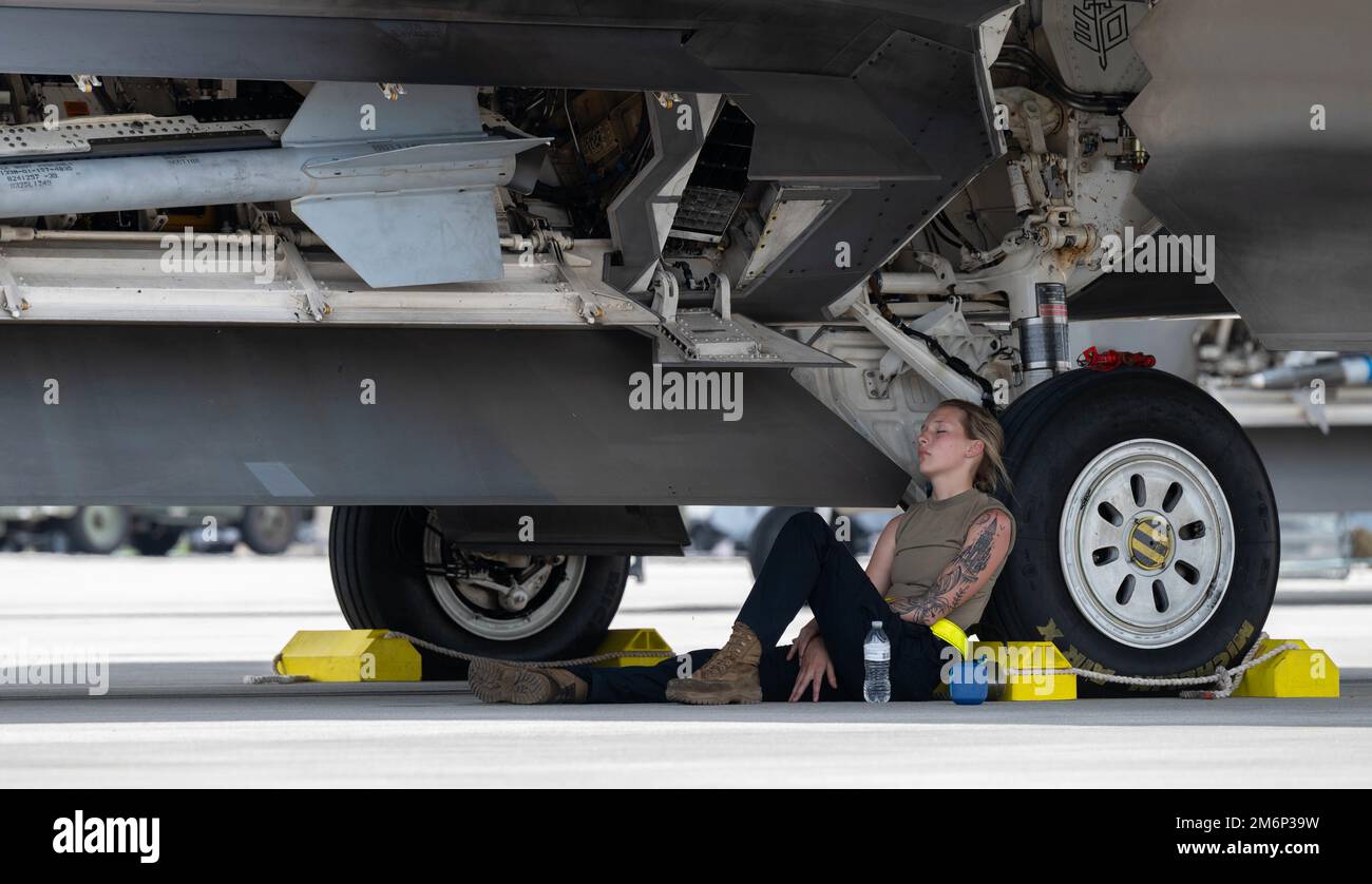 STATI UNITI Air Force Airman 1st Class Megan Siver, 43d Fighter Generation Squadron assistente dedicato capo equipaggio, si appoggia contro il pneumatico di un F-22 Raptor a Savannah Hilton Head International Airport, Georgia, 3 maggio 2022. La 325th Fighter Wing ha inviato più di 200 persone e 22 aerei a partecipare a Sentry Savannah, un esercizio di addestramento vicino ai pari ospitato dal Air Dominance Center della Guardia Nazionale aerea. Foto Stock