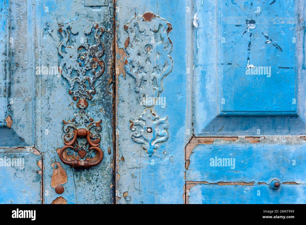 Vecchia porta di legno blu e serratura deteriorata dal tempo e ruggine in una casa di stile coloniale Foto Stock