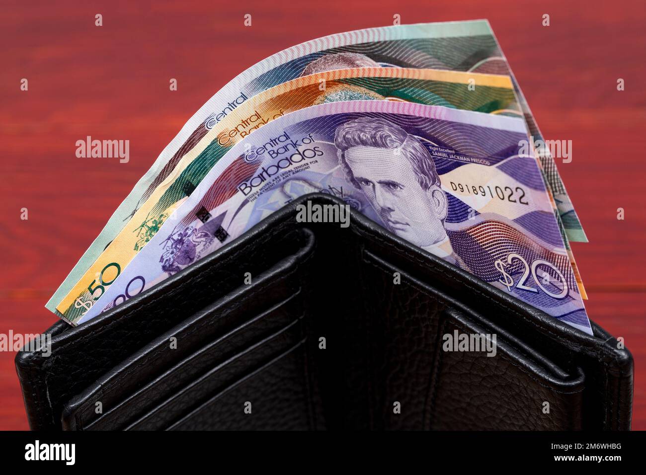Dollaro barbadiano nel portafoglio nero Foto Stock