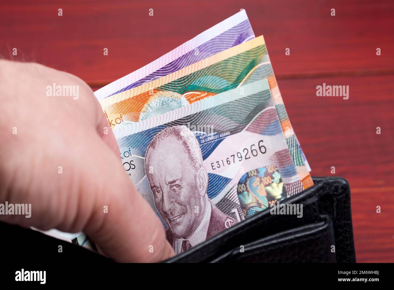 Dollaro barbadiano nel portafoglio nero Foto Stock