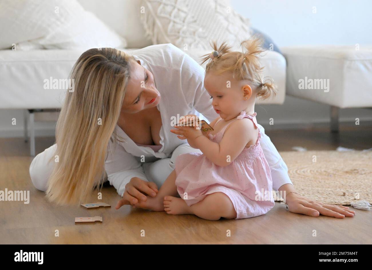 Madre che gioca con la ragazza, bambino, 11 mesi, sul pavimento, giocattoli, Baden-Wuerttemberg, Germania Foto Stock