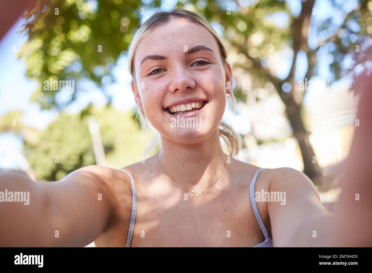 Selfie, parco e ritratto di donna in estate godendo vacanza, vacanza e weekend in natura. Libertà, stile di vita felice e faccia della ragazza che scatta la foto Foto Stock