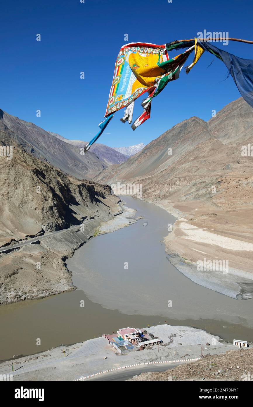 Confluenza dei fiumi Indus e Zanskar nell'Himalaya, bandiera di preghiera di fronte, Valle Indus, Ladakh, India Foto Stock