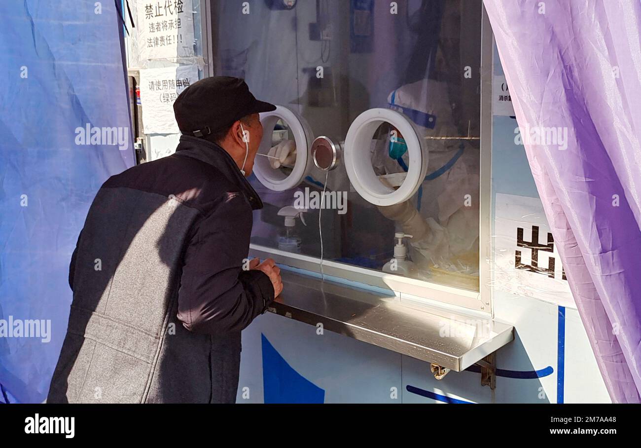 La gente prende i loro ultimi campioni liberi di test di acido nucleico ad un chiosco a Shanghai, Cina, 7 gennaio 2023. A partire da gennaio 8, in aggiunta al personale o Foto Stock