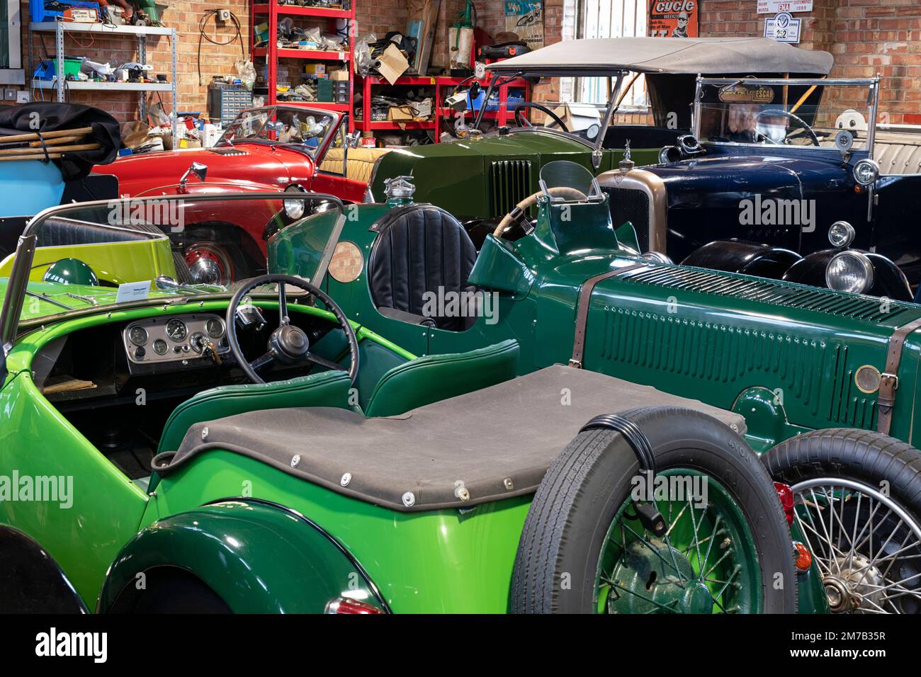 All'interno di un'officina di auto classica al Bicester Heritage Centre, evento di gara domenicale. Oxfordshire, Inghilterra. Foto Stock