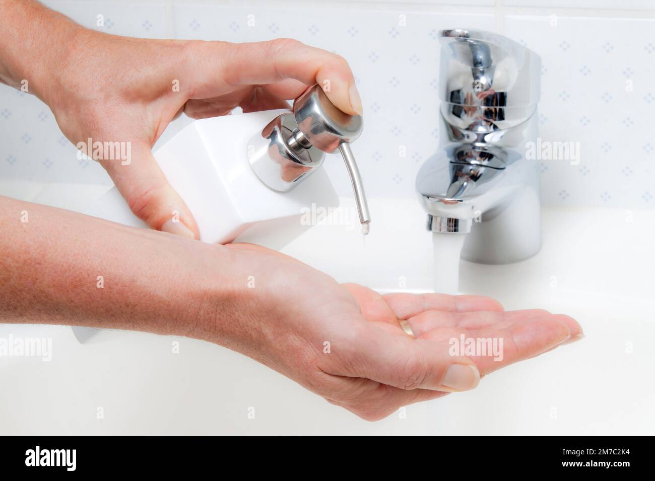 La donna lava le mani sotto acqua corrente e sapone Foto Stock