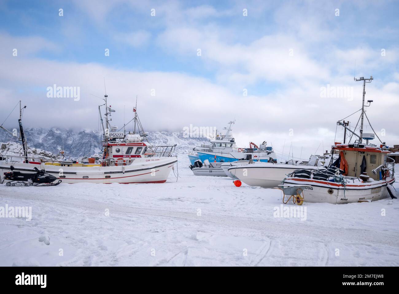 Le barche da pesca congelate nel ghiaccio marino nel porto di Uummannaq, nella Groenlandia occidentale Foto Stock