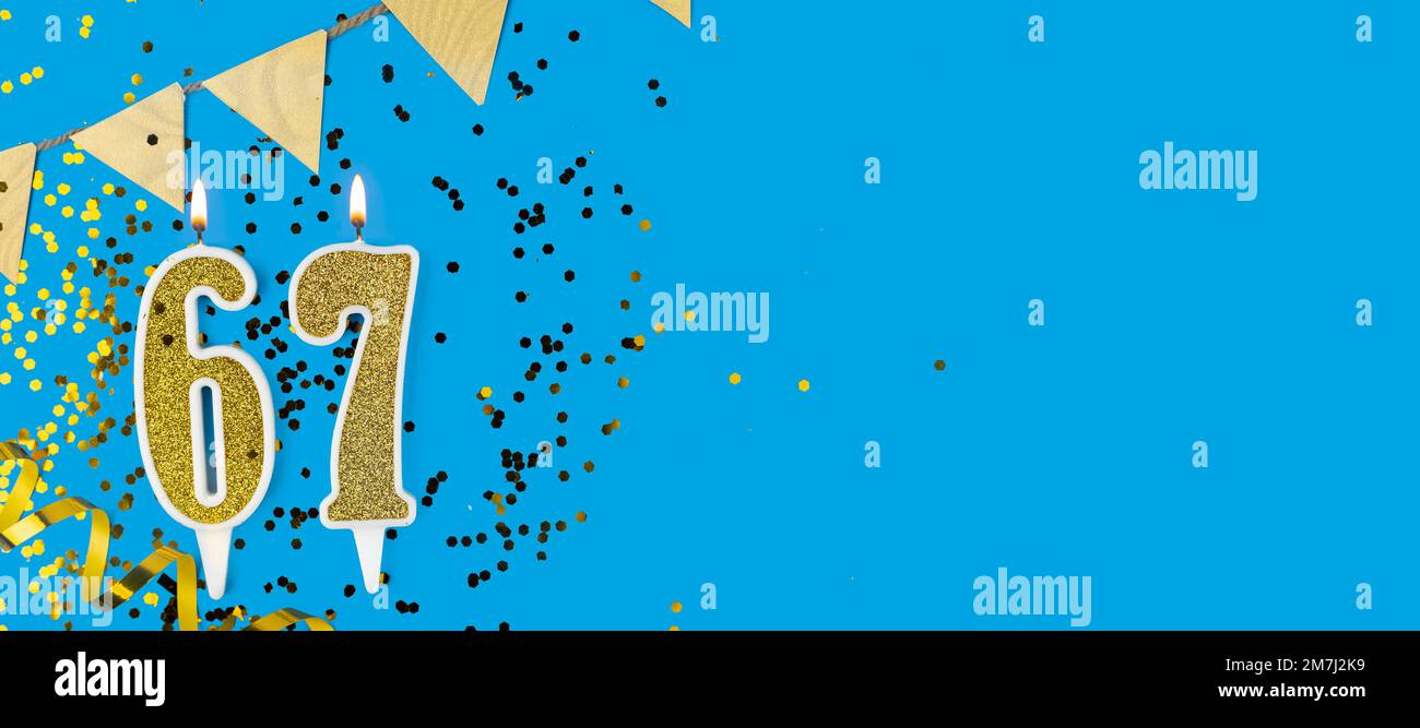 Candela d'oro numero sessantasette. Cartellino di compleanno o anniversario con l'iscrizione 67 su sfondo blu. Celebrazione dell'anniversario. Banner. Foto Stock