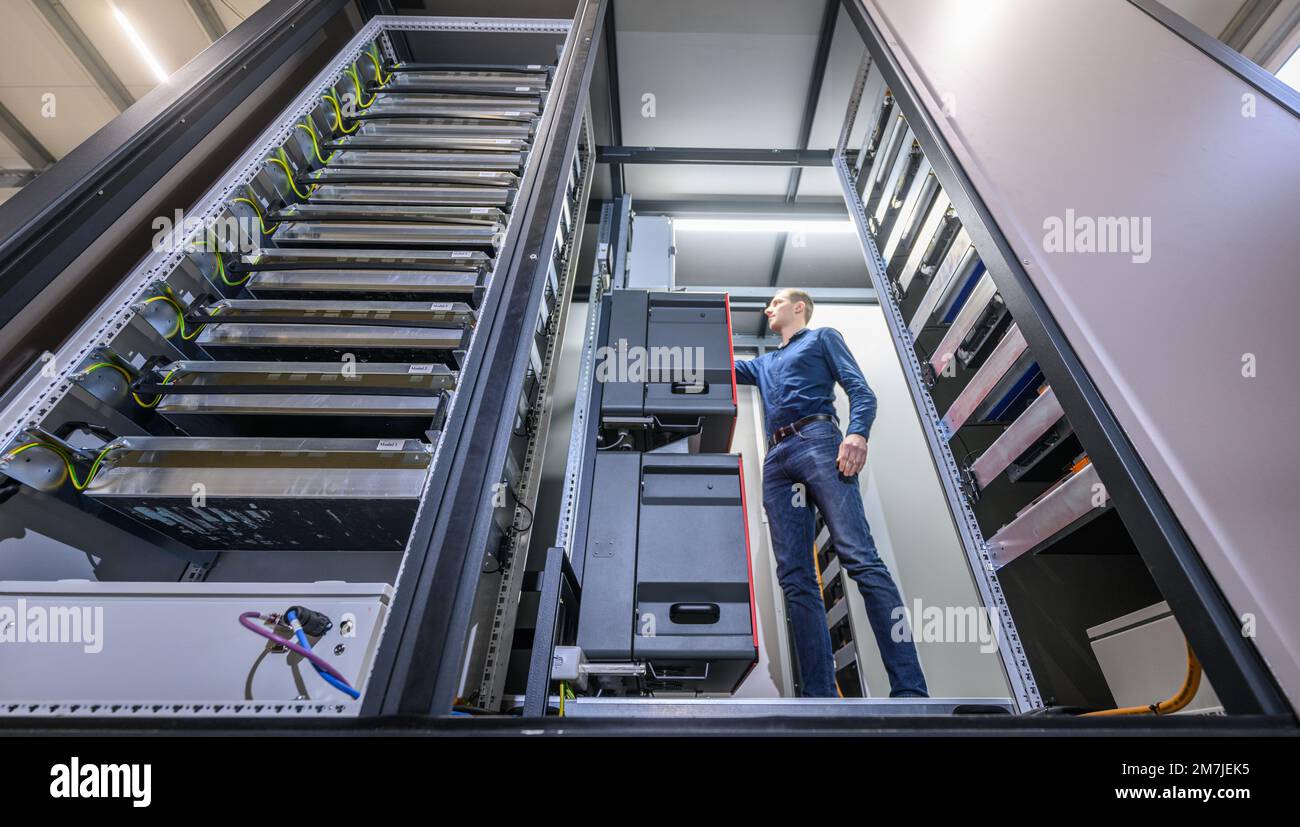 Zwickau, Germania. 10th Jan, 2023. Robin Anderfuhr, dipendente della società Ekon GmbH, è presente in una grande unità di archiviazione mobile basata su batterie agli ioni di litio usate prima dell'inizio della presentazione per il completamento ufficiale. Tali unità di stoccaggio potrebbero contribuire a immagazzinare energia dalle celle solari o dalle turbine eoliche in futuro. Credit: Robert Michael/dpa/Alamy Live News Foto Stock