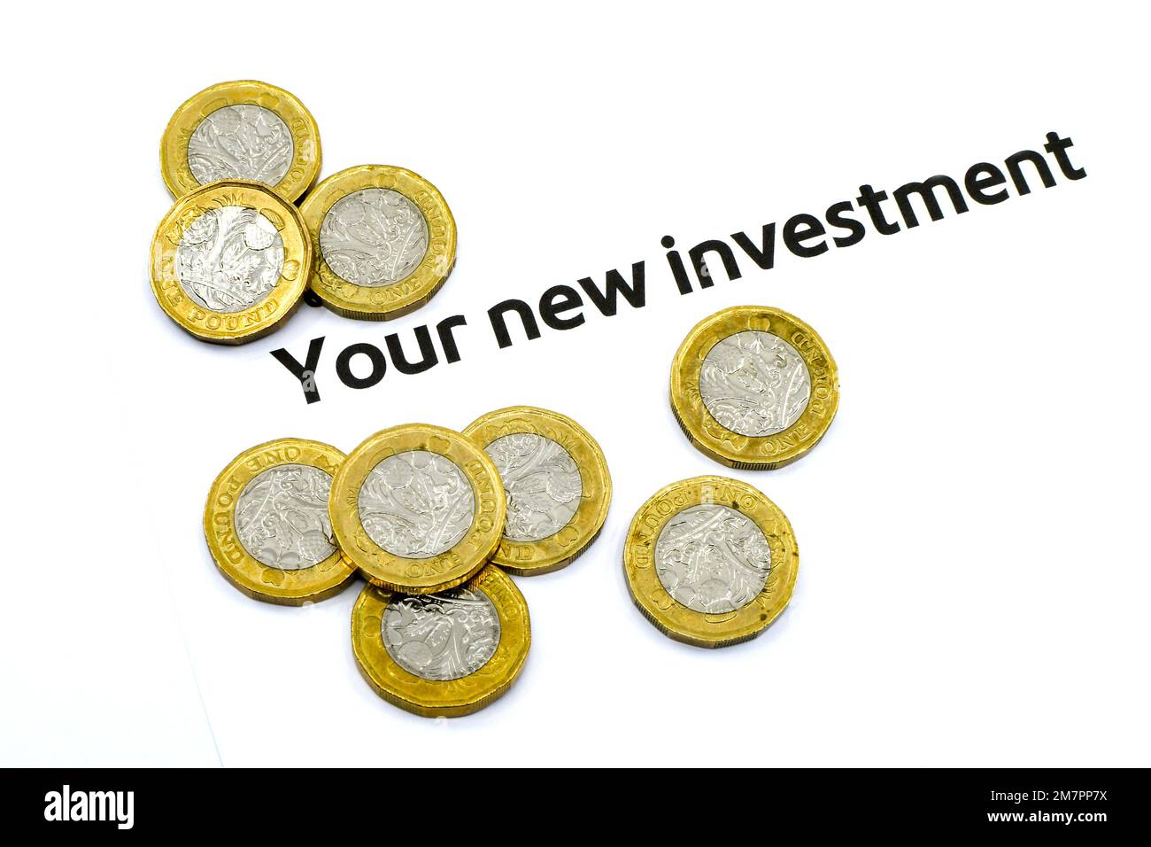 Monete da una libbra accanto all'intestazione di una lettera sui nuovi investimenti. Concetto di risparmio. Spazio di copia. Foto Stock