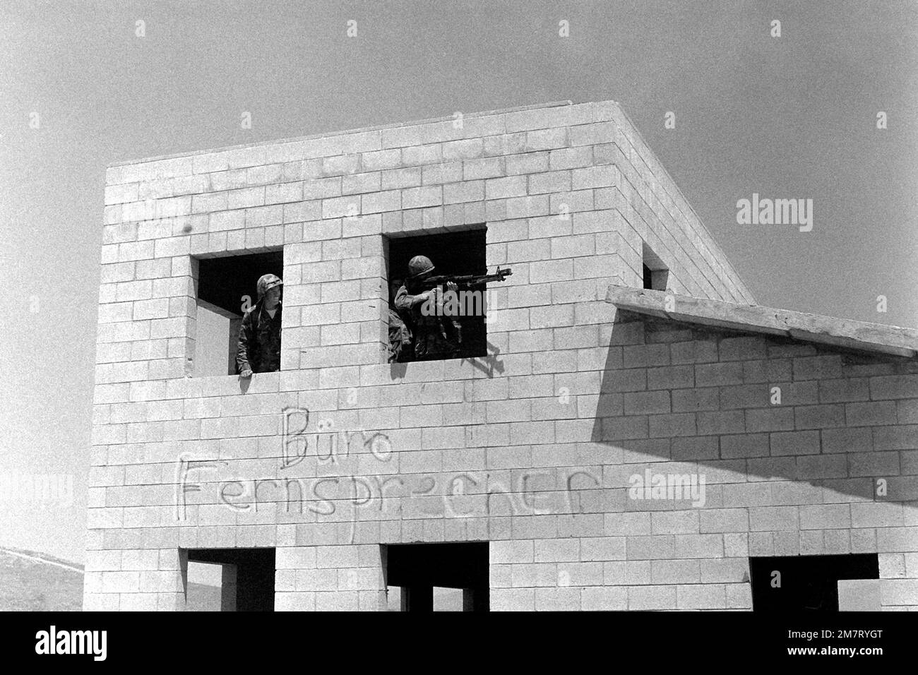 Durante un assalto a Combat Town, due Marines del 1st battaglione, 9th Marines, sono alle finestre di uno degli edifici. Uno dei Marines sta sparando la sua mitragliatrice M-60A1 dalla finestra. Base: Marine Corps base Camp Pendleton Stato: California (CA) Paese: Stati Uniti d'America (USA) Foto Stock