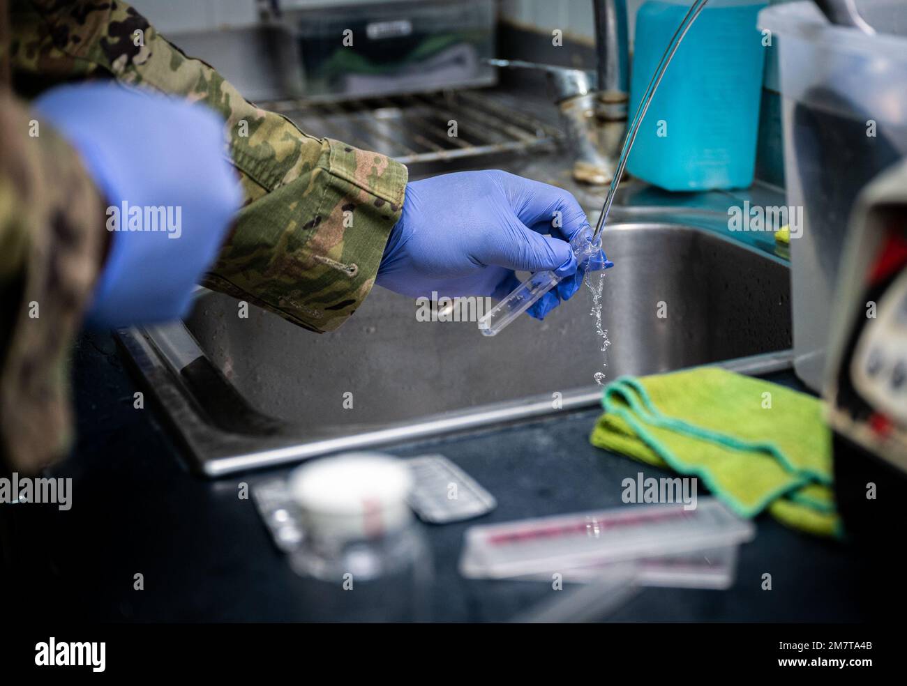 Senior Airman Kevin Thompson, 332d ingegnere civile di spedizione Squadron forza protezione e salute pubblica viaggio, raccoglie un campione d'acqua in una caffetteria di base per testare per intervalli accettabili in pH e cloro in una posizione non divulgata nel sud-ovest asiatico, 11 maggio 2022. Foto Stock