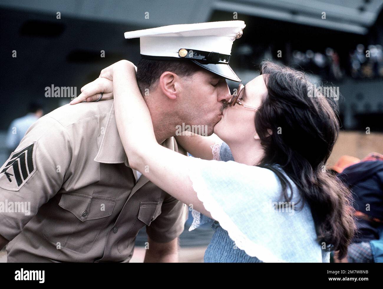 Un sergente marina assegnato a bordo della portaerei nucleare USS ENTERPRISE (CVN-65) bacia sua moglie. L'IMPRESA è tornata al porto da una breve crociera dopo il completamento dei lavori di ristrutturazione che hanno incluso la ricostruzione della sovrastruttura. Base: Naval Air Station, Alameda Stato: California (CA) Paese: Stati Uniti d'America (USA) Foto Stock