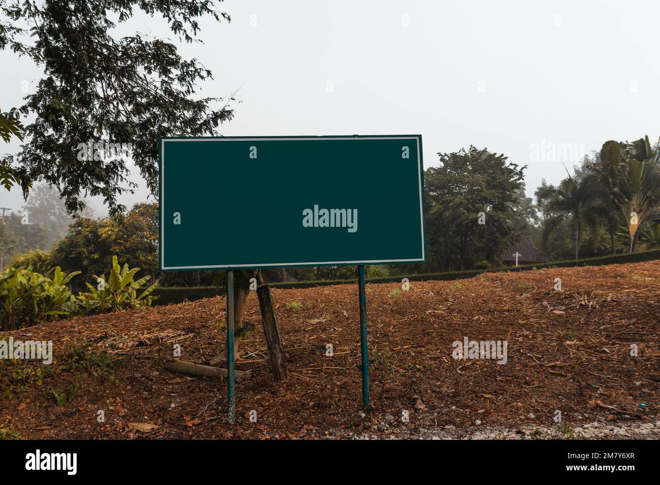 Cartello verde vuoto, strada nella campagna nord della Thailandia. Con tracciato di ritaglio. Foto Stock