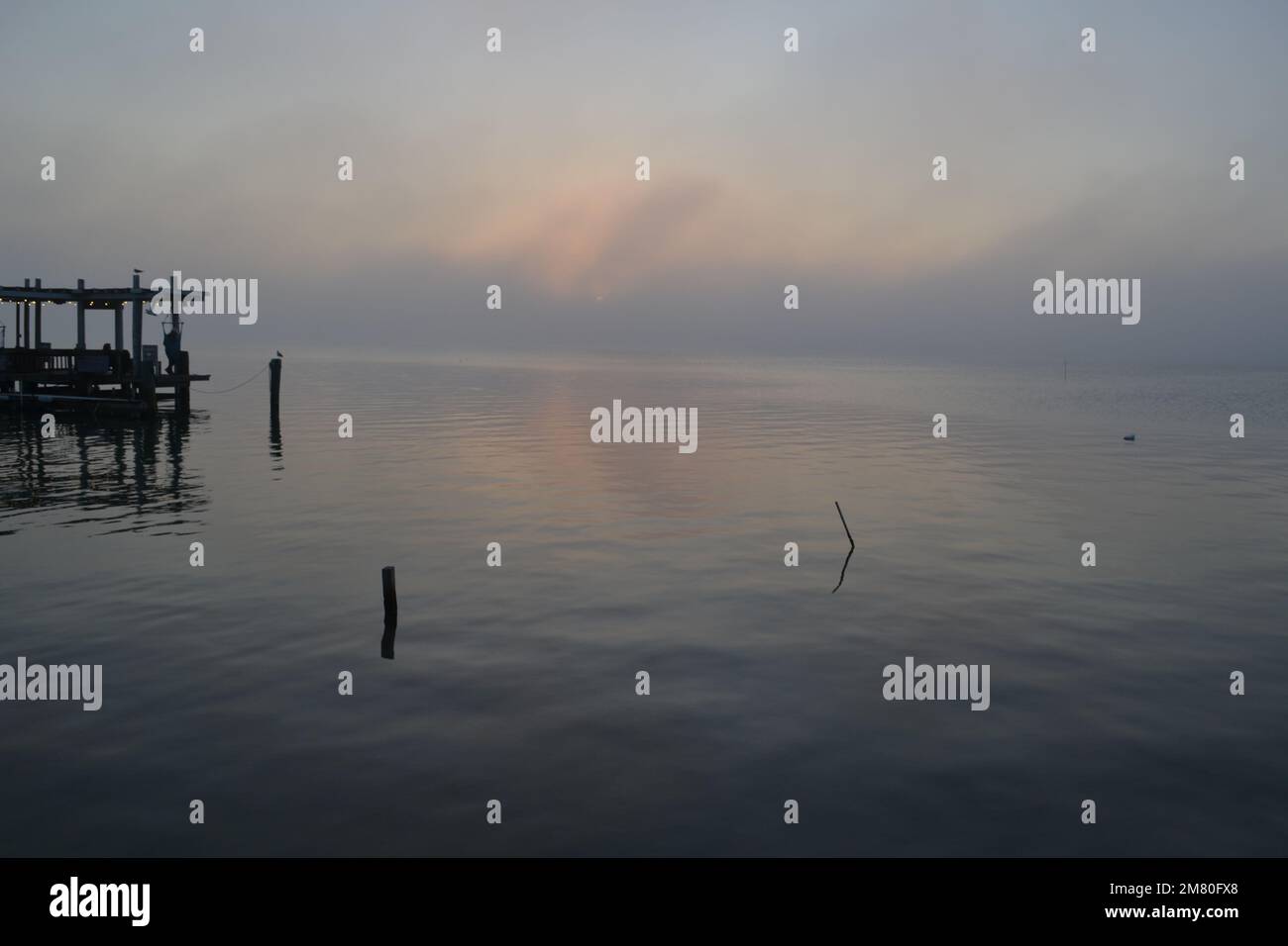 Tramonto mozzafiato sulle calme acque di Laguna madre a South padre Island, Texas: Un'ora d'oro di tranquillità in un paradiso tropicale costiero Foto Stock