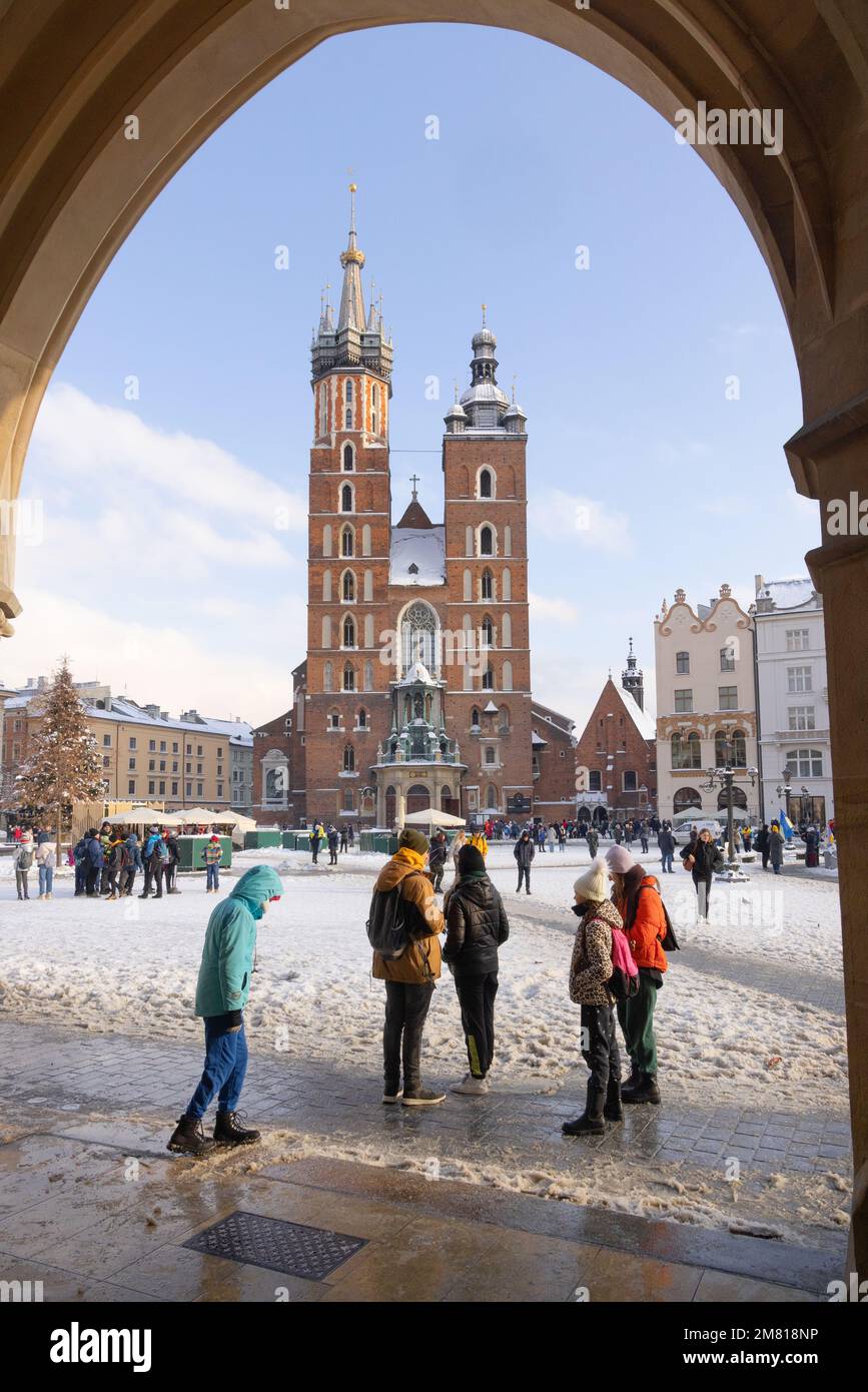 Cracovia Polonia; Basilica di Santa Maria, una chiesa gotica nella Piazza del mercato di Cracovia nella neve d'inverno, vista dal Palazzo dei tessuti, dalla Città Vecchia di Cracovia, dalla Polonia Europa Foto Stock