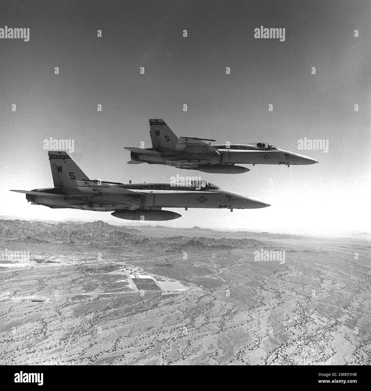 Una vista dal lato destro aria-aria di due aerei Marine Fighter Attack Squadron 323 (VMFA-323) F/A-18A Hornet. Gli aerei sono in volo sopra l'area operativa della California del Sud vicino alla Stazione aerea del corpo Marino, Yuma, Ariz.. Stato: California (CA) Paese: Stati Uniti d'America (USA) Foto Stock