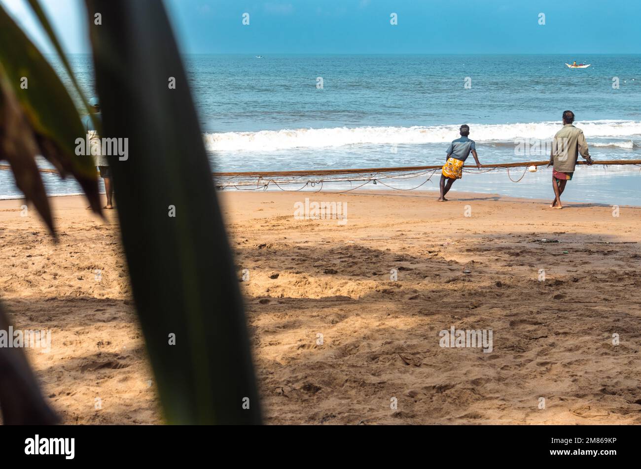 I pescatori tirano le loro reti sulla spiaggia. Foto Stock