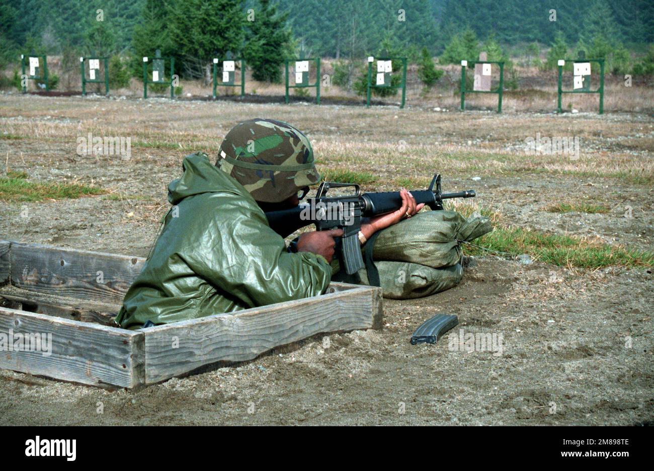 Un membro della divisione fanteria 9th spara un fucile M16A1 durante l'addestramento delle armi pre-dispiegamento. Le unità della 9th° Divisione Fanteria si recheranno in Corea del Sud per partecipare alla squadra di allenamento CONGIUNTA sudcoreana/americana SPIRIT '88. Soggetto operativo/Serie: TEAM SPIRIT '88 base: Fort Lewis Stato: Washington (WA) Paese: Stati Uniti d'America (USA) Foto Stock