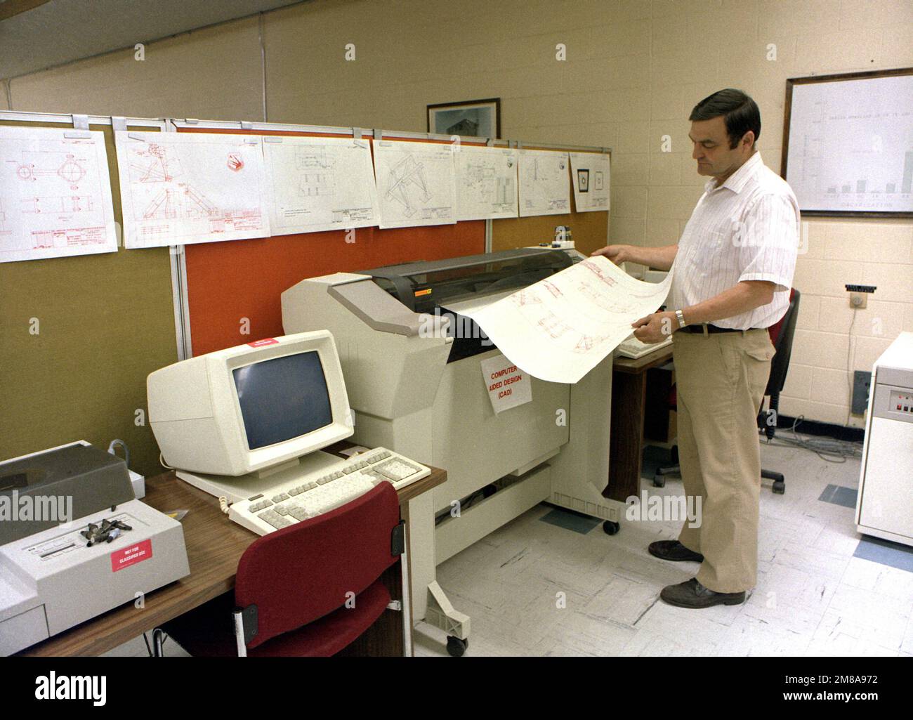 Un tecnico monitora una stampa mentre utilizza il sistema CAD (computer Aided Design) per sviluppare il sistema di montaggio per la sezione di coda del bombardiere B-1. Base: Roma Stato: New York (NY) Paese: Stati Uniti d'America (USA) Foto Stock