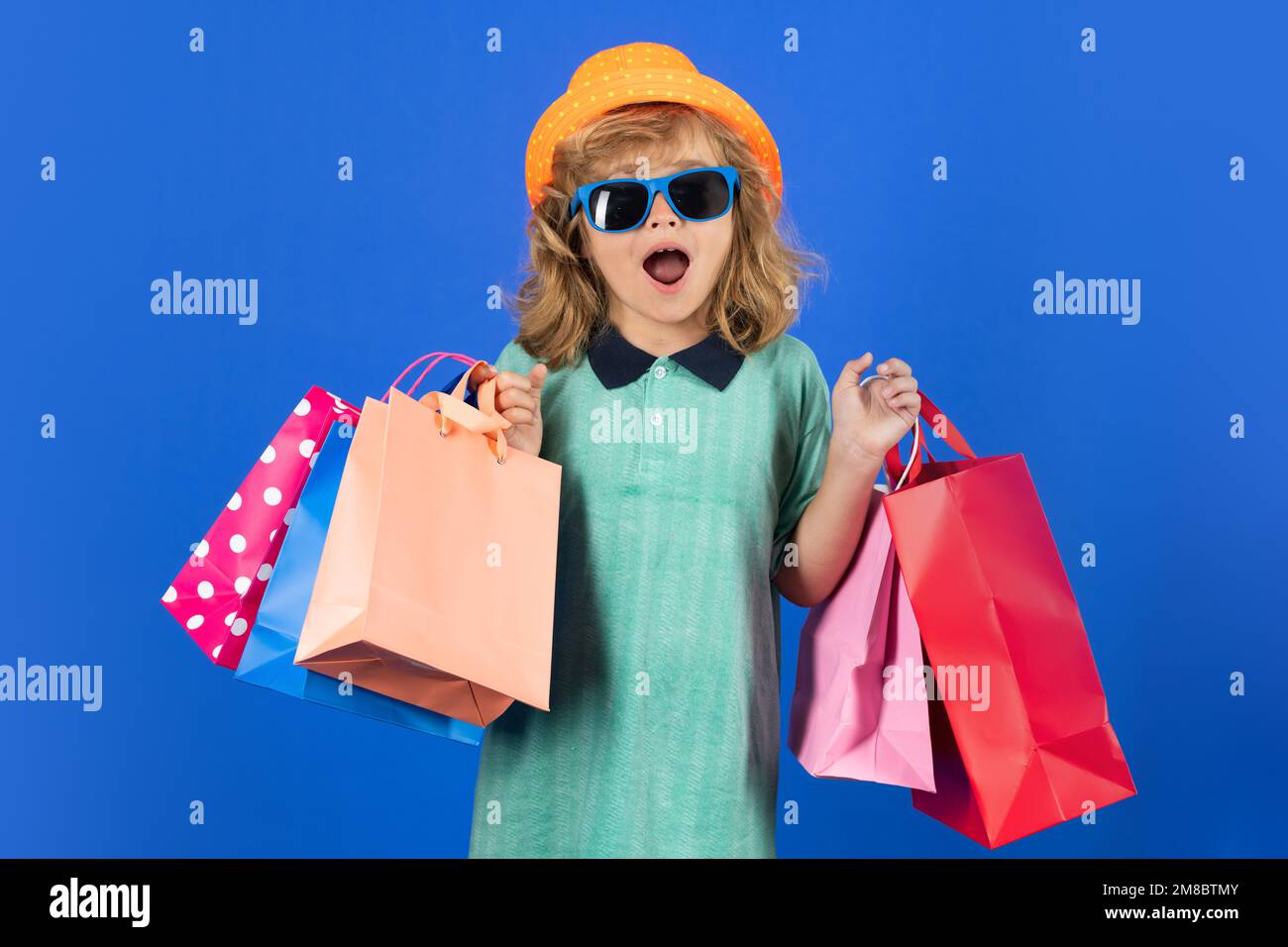 Bambino ragazzo in abiti di moda va shopping. Bambini con pacchetti  shopping. Shopper bambino con borse per la spesa Foto stock - Alamy