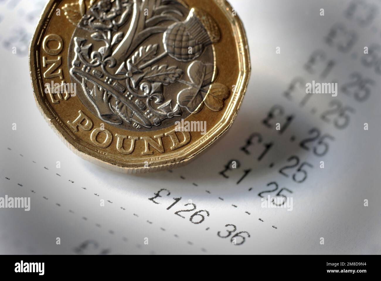 BOLLETTA ALIMENTARE SUPERMERCATO CON UNA MONETA DA UNA LIBBRA RE RE COSTO DI VITA CRISI REDDITI SPESA SHOPPING INFLAZIONE PREZZI IN AUMENTO ECC UK Foto Stock