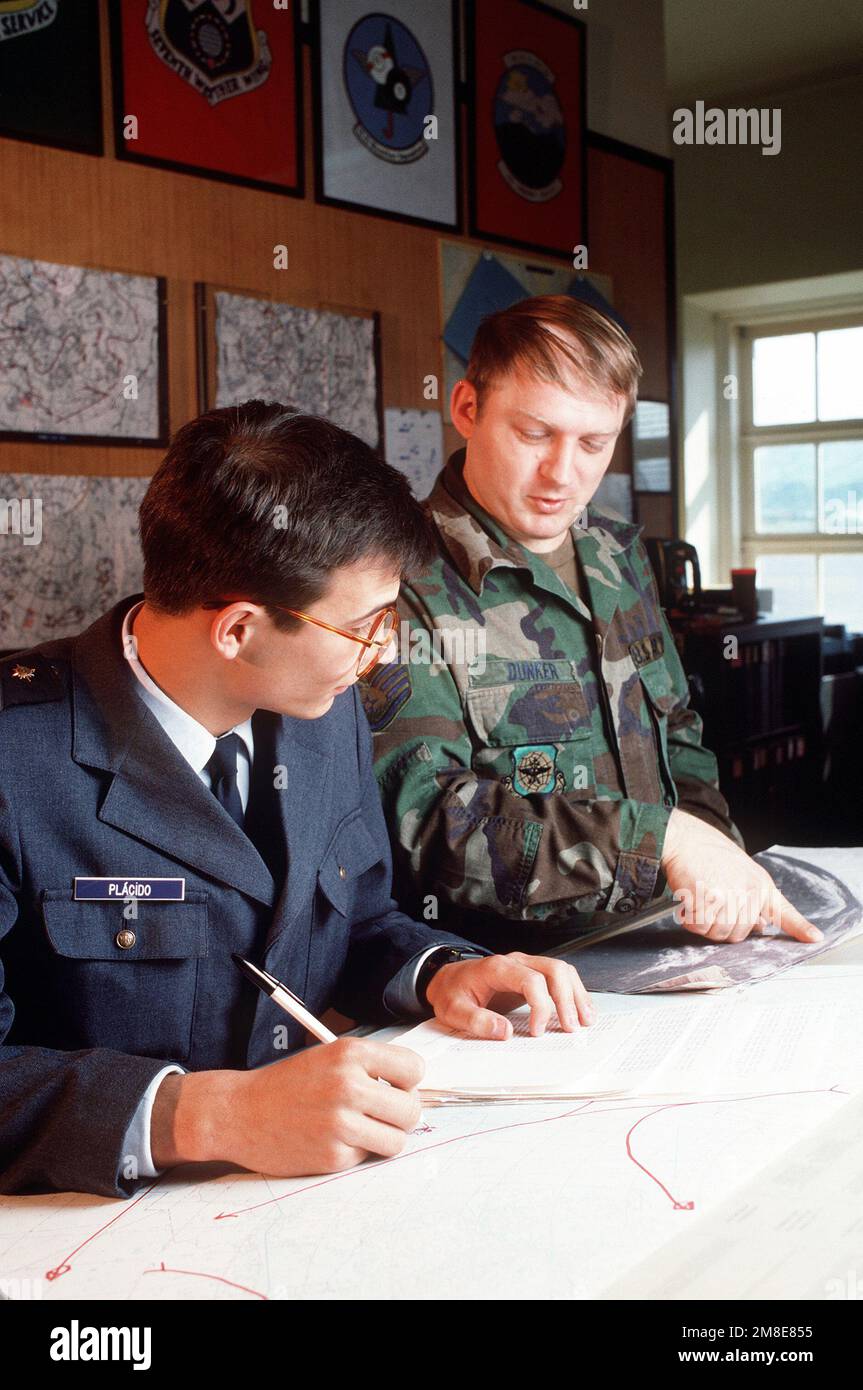 SSGT Tom Dunker, giusto, un americano Air Force meteo previsore, lavora con il suo omologo portoghese come grafico informazioni da una fotografia satellitare. Base: Lajes Field Stato: Azzorre Paese: Portogallo (PRT) Foto Stock