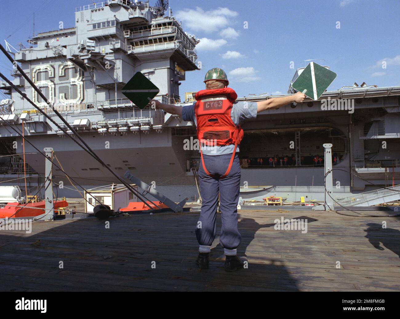 Un equipaggio, in piedi sul ponte della nave da guerra IOWA (BB-61), segnala alla portaerei USS KITTY HAWK (CV-63) durante un esercizio di rifornimento in corso. L'IOWA è stata smantellata il 26 ottobre 1990 ed è attualmente immagazzinata nel cantiere navale. Base: Philadelphia Stato: Pennsylvania (PA) Paese: Stati Uniti d'America (USA) Foto Stock