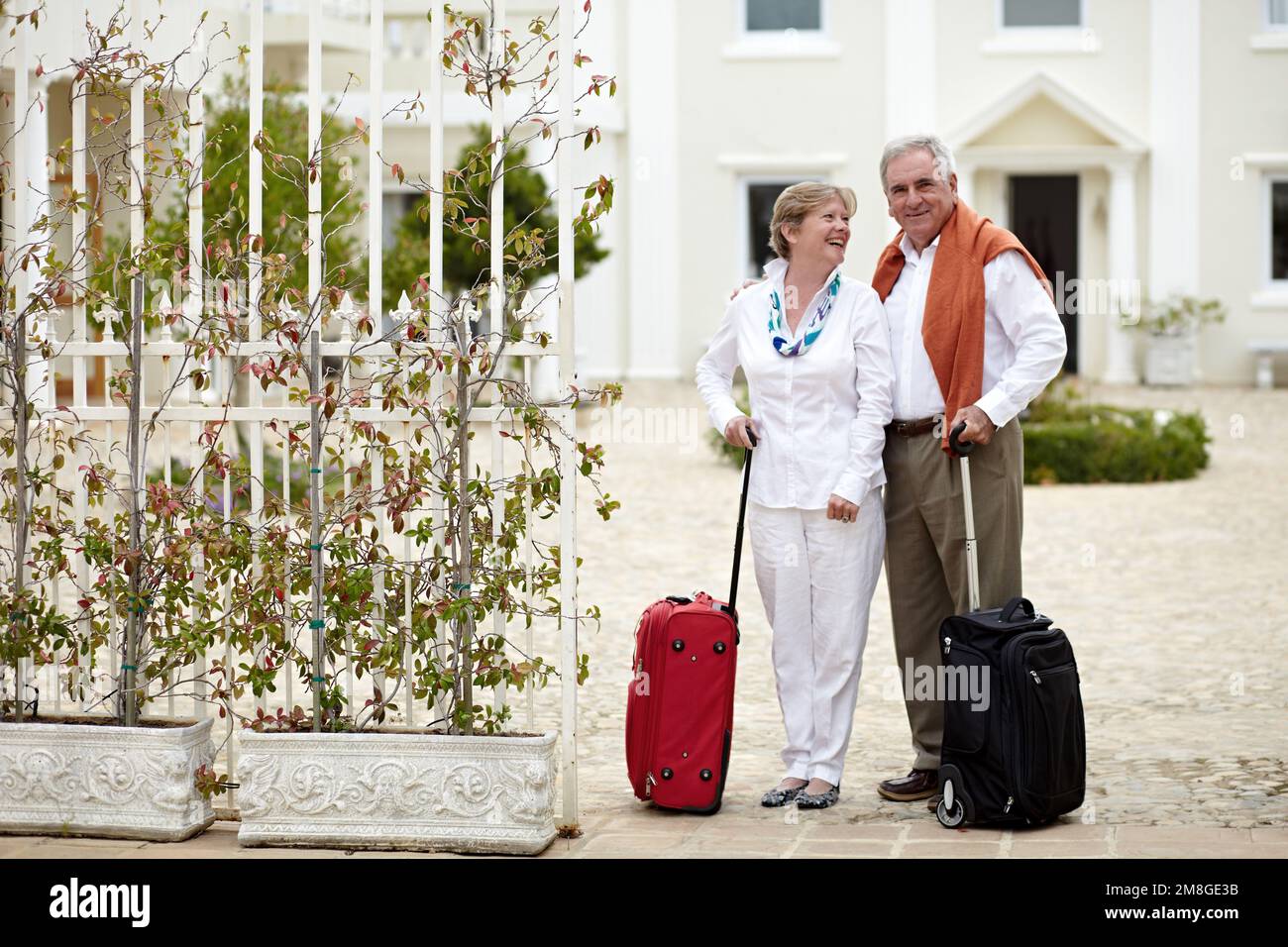 Mi piace portarla in luoghi lontani. una coppia anziana in piedi con le valigie durante la vacanza. Foto Stock