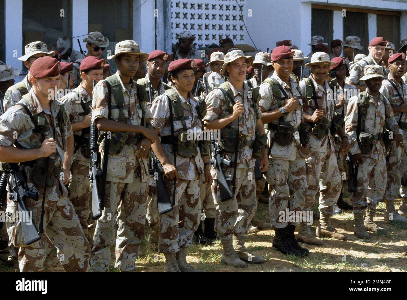 Soldiers of Headquarters Company, 507th Corps Support Group (Airborne), Fort Bragg, NC, wait patiently in formation for their next redeployment briefing. They are preparing to depart the University compound where they have been supporting UNOSOM II, for the airport and a plane ride home. Subject Operation/Series: UNOSOM II Base: Mogadishu Country: Somalia (SOM) Foto Stock