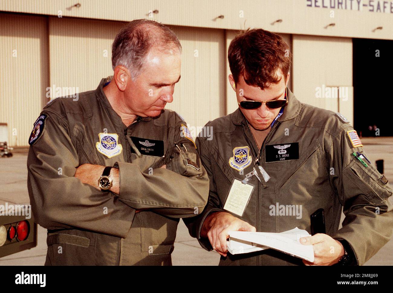 LT. COL. Greg Smith (a sinistra), comandante della missione per il flusso d'aria e il capitano David S. Argyle, vice comandante della missione, entrambi della 438th Airlift Wing, McGuire AFB, NJ, guardano i documenti di pianificazione del carburante per la missione. Soggetto operativo/Serie: BASE DI SOLLEVAMENTO DELL'UGANDA: Base aerea Rhein-Main Paese: Deutschland / Germania (DEU) Foto Stock