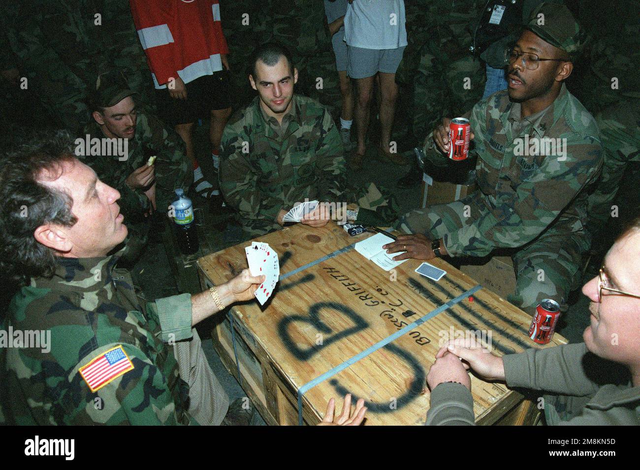 Il cantante di musica country Larry Gatlin gioca a carte con Seabees of Naval Mobile Construction Battalion One-Thirty-Three (NMCB-133) durante una speciale visita del giorno di Natale. Il sig. Gatlin ha eseguito per i Seabees ad un'ex rivista missilistica scud della base dell'esercito russo ora convertita in una stanza a castello di 200 uomini a sostegno dell'operazione Joint Endeavor, una missione di mantenimento della pace in Croazia. Oggetto operazione/Serie: JOINT ENDEAVOR base: Zapanja Paese: Croazia (HRV) Foto Stock