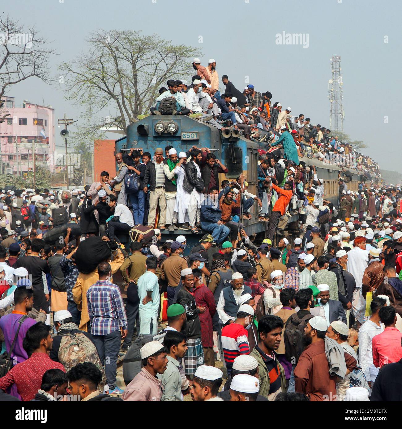 Dhaka, Bangladesh. 15th Jan, 2023. I devoti musulmani viaggiano su treni rischiosi sovraffollati dopo aver assistito all'Akheri Munajat o alle preghiere finali, al Biswa Ijtema di Tongi, Dhaka, Bangladesh. Gli abitanti del luogo affrontano il viaggio salendo, aggrappandosi ai tetti delle locomotive. Senza posti a sedere disponibili all'interno, molti pendolari decidono di correre il rischio e di scegliere una vista sul tetto per il loro viaggio fuori dalla città di Dhaka.milioni di devoti musulmani da tutto il mondo si uniscono all'evento di quattro giorni che culmina nell'Akheri Munajat o nella supplica conclusiva (preghiera finale) in cui i musulmani r Foto Stock