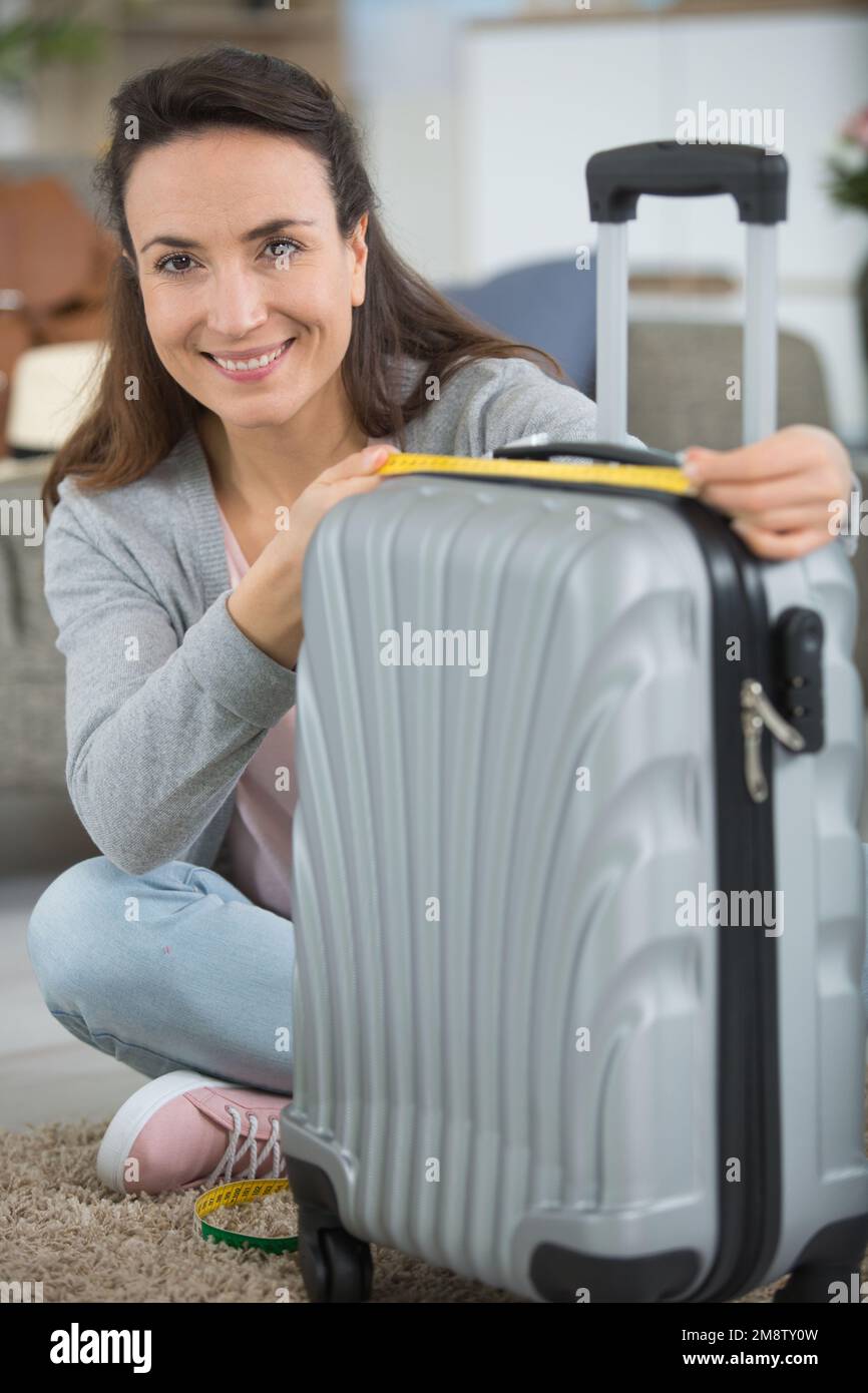 donna che misura la sua borsa della cabina Foto Stock