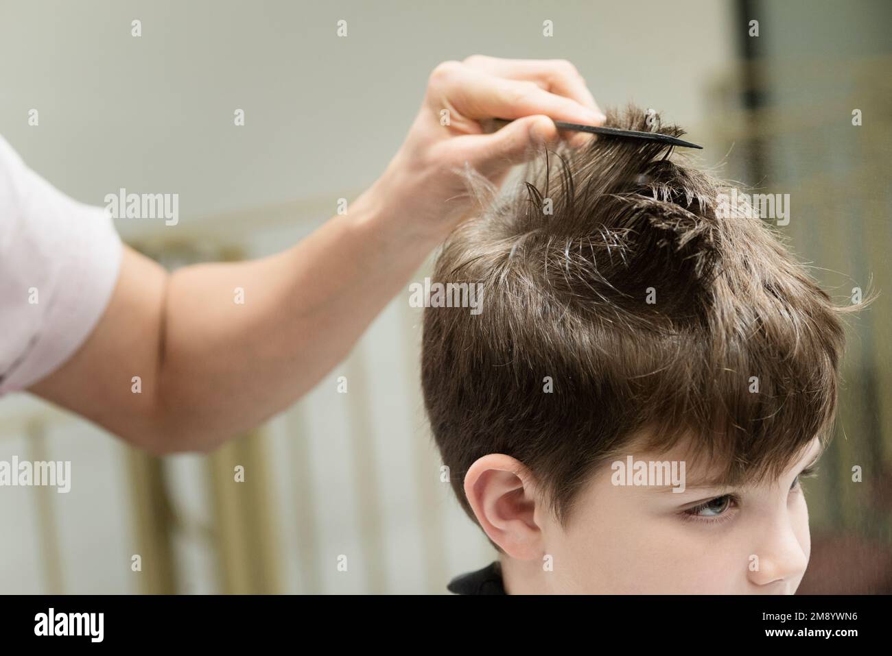 Un piccolo ragazzo in un parrucchiere Salon Foto Stock