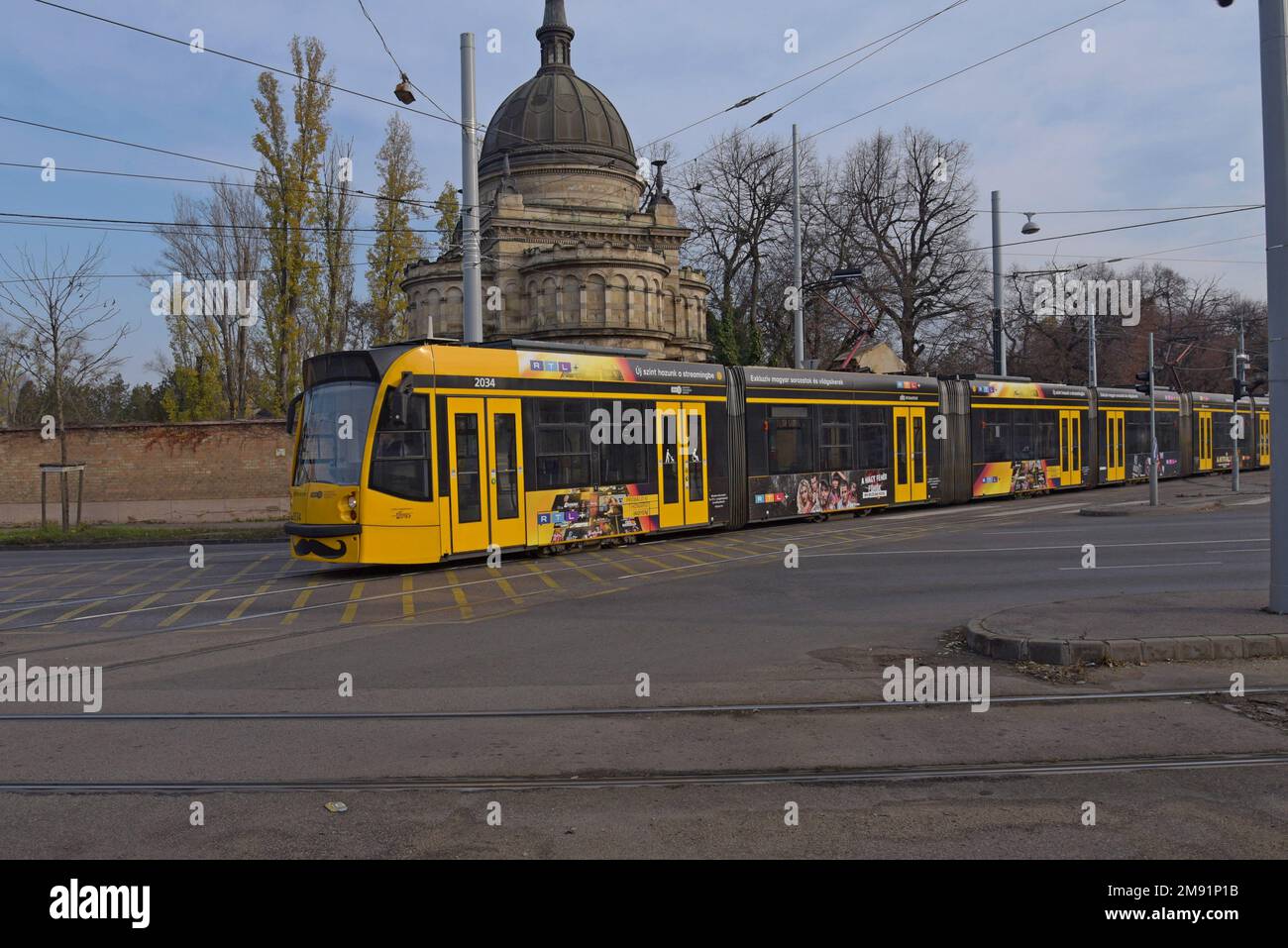 Un tram Siemens Avenio a piano basso che passa davanti al Ganz mauzóleum, Budapest, Ungheria Foto Stock