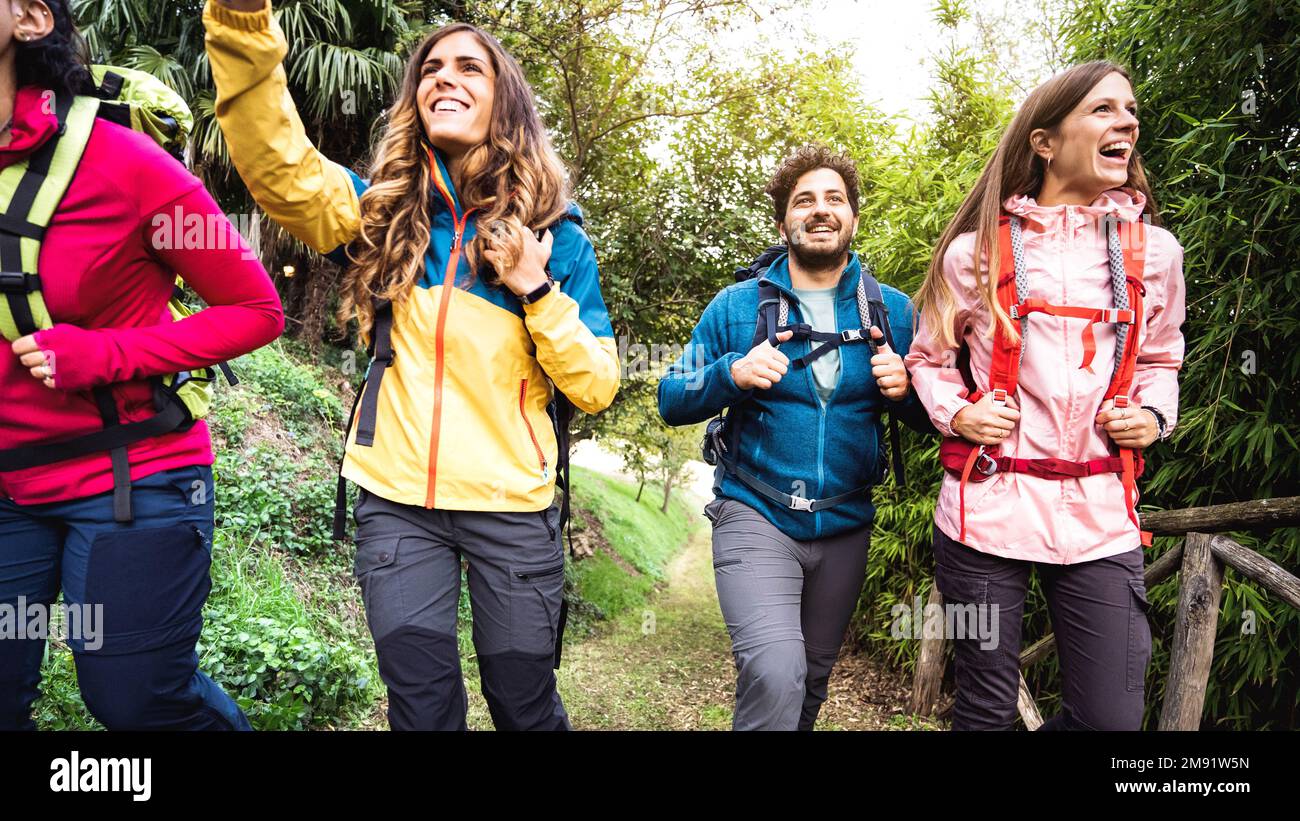 Vista frontale della gente gruppo trekking nei boschi delle alpi europee - escursionisti con zaino a piedi intorno alla foresta di montagna selvaggia - Wanderlust concetto di viaggio w Foto Stock