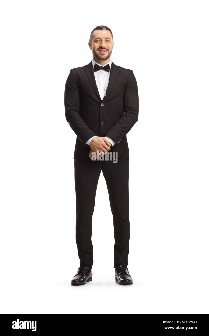 Ritratto completo di un bell'uomo in tuta nera con cravatta ad arco isolata su sfondo bianco Foto Stock