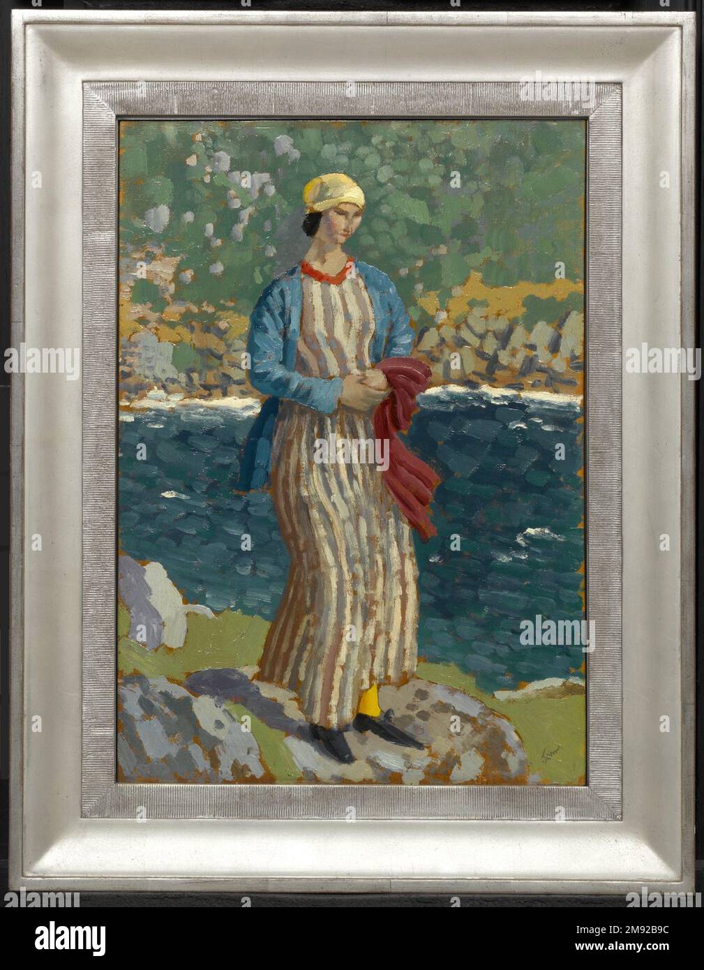 Donna di un Riverbank Augustus John (britannico, 1878-1961). Donna di un Riverbank, ca. 1910-1912. Olio sul pannello, 18 x 12 1/2 in. (45,7 x 31,8 cm). Utilizzando tocchi audaci di pigmenti non miscelati, Augustus John dipinse il suo compagno Dorothy (“Dorelia”) McNeill indossando indumenti dai colori vivaci che riflettono il loro interesse condiviso per gli abiti non convenzionali e per la cultura romanica, un fascino per tutta la vita per l’artista. Qui, Dorelia appare come una Venere bohémien sulle rive di un'arcadia selvaggia, immaginata che era, in realtà, probabilmente un villaggio di pescatori in Provenza. Arte europea ca. 1910-1912 Foto Stock