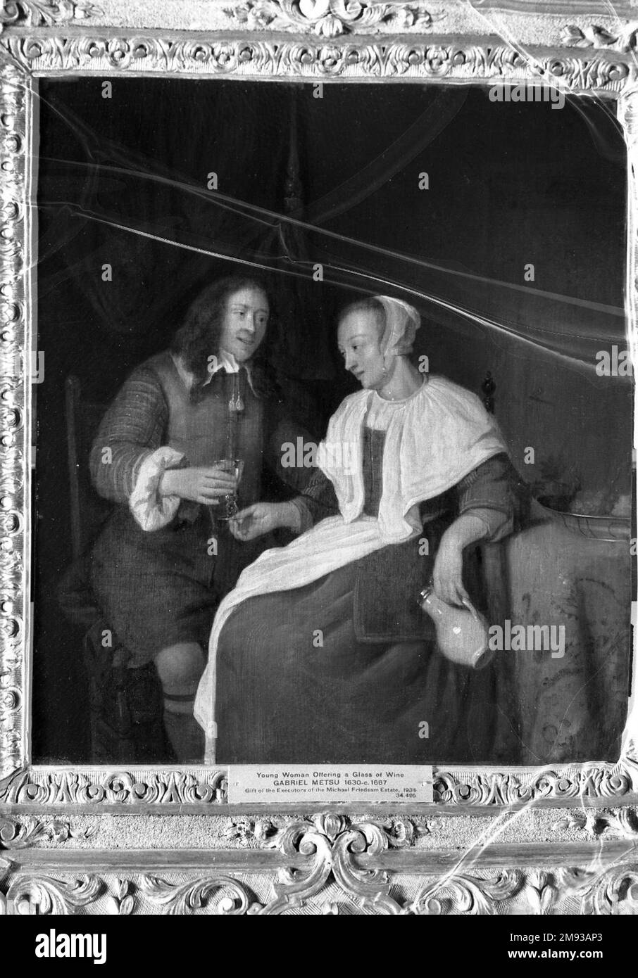 Giovane donna che offre un bicchiere di vino ad un soldato alla maniera di Gabriel Metsu (olandese, 1629-1667). Giovane donna che offre un bicchiere di vino ad un soldato. Olio sul pannello, 14 1/8 x 11 3/4 in. (35,9 x 29,8 cm). Arte europea Foto Stock