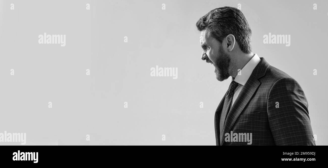 Uomo volto ritratto, banner con spazio copia. Uomo d'affari in tuta, sfondo isolato studio, banner poster. Mi fai urlare. Ragazzo arrabbiato grido lato-faccia Foto Stock