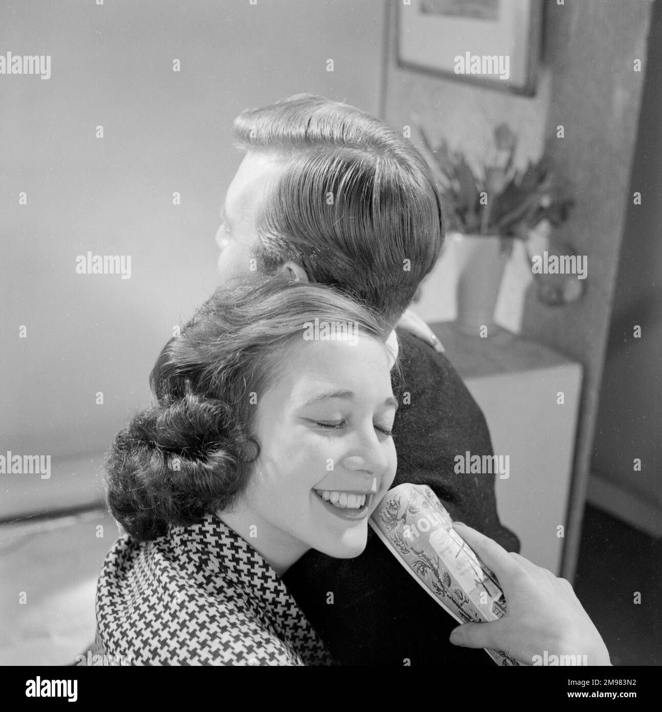 Pubblicità per i prodotti per capelli Silvikrin -- modelli maschili e femminili in posa (Jeremy Dempster e Pam Rhodes). Foto Stock