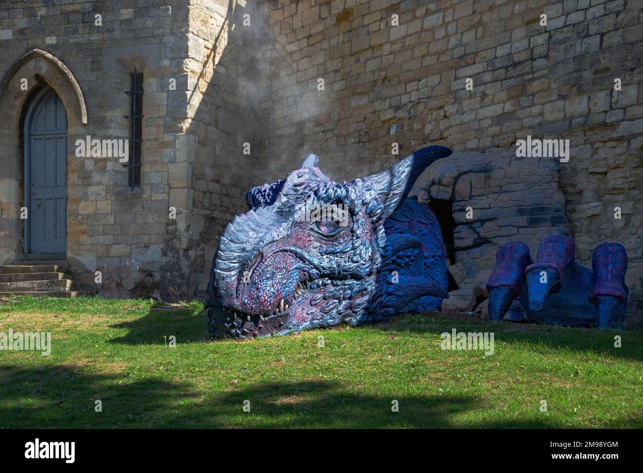 Lucy il drago che si rompe attraverso un muro del castello di Lincoln. Foto Stock